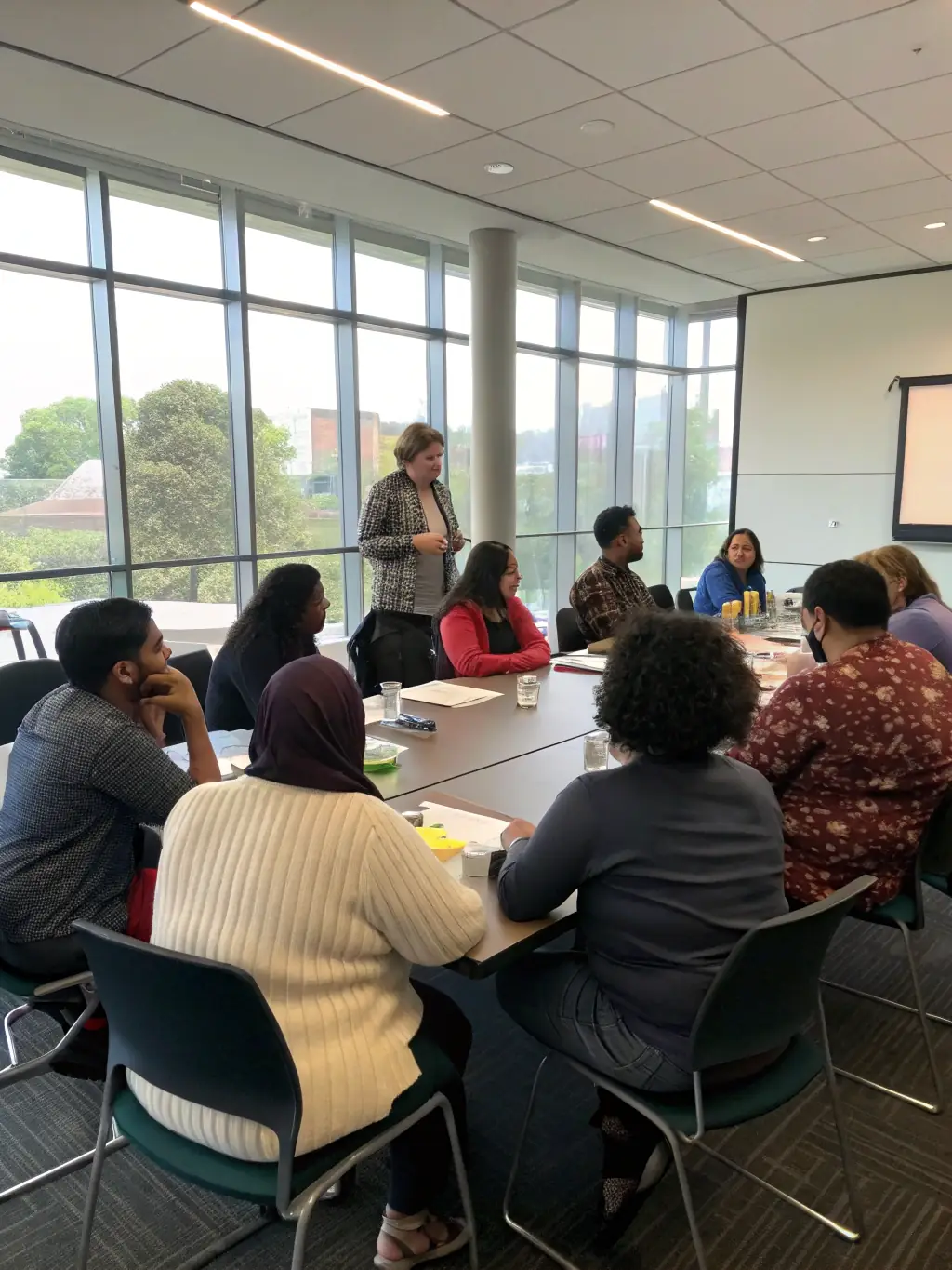A dynamic image of a public speaking workshop, featuring participants actively engaged in discussions and practicing their presentation skills, held at ASSOCIATION MULTICULTURELLE CRITEUILLOISE.