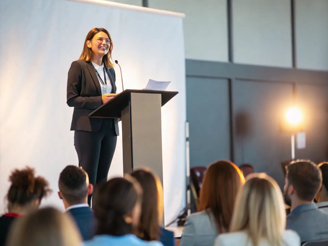 A dynamic image of a speaker presenting at a conference organized by ASSOCIATION MULTICULTURELLE CRITEUILLOISE, capturing the essence of knowledge sharing and intellectual discourse.